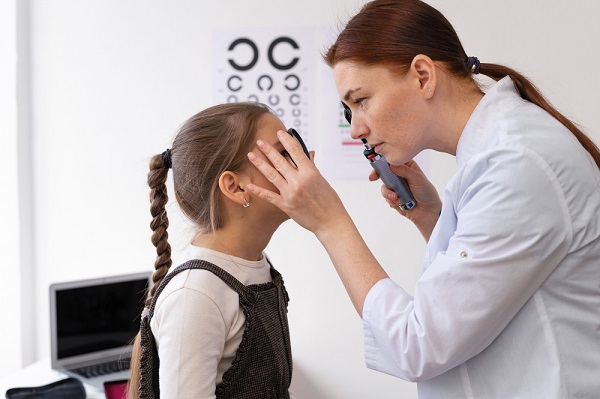 Médica oftalmologista testando a visão de uma menina.